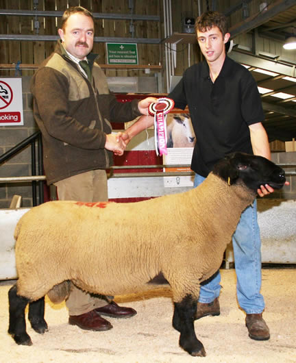 With his Skipton multi-breed Suffolk champion Stephen Bolland, right, receives the victor’s spoils from judge Craig Bradbury, Diggle