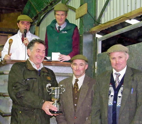Pictured (from left) Simon Bedell presents the cup to Philip and Michael Wood watched by Halls auctioneers James Evans and Peter Willcock