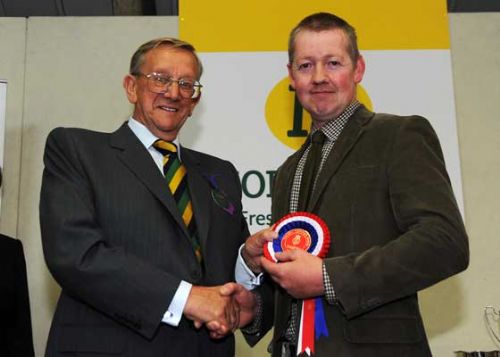 David Heap of Calderdale Cheese Company receiving the Supreme Championship award from Sir Ken Morrison.