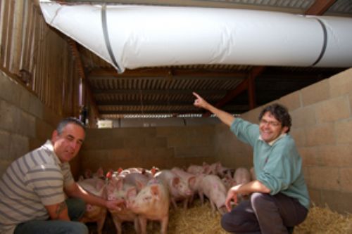 Derek Buckmaster (left) with Tim Miller, who advised installing the ducting ventilation system which solved a dirty pens problem.