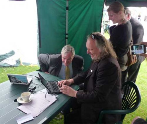 Defra Minister Lord Henley (l) learns the finer points of social media during National Countryside Week on the CLA stand