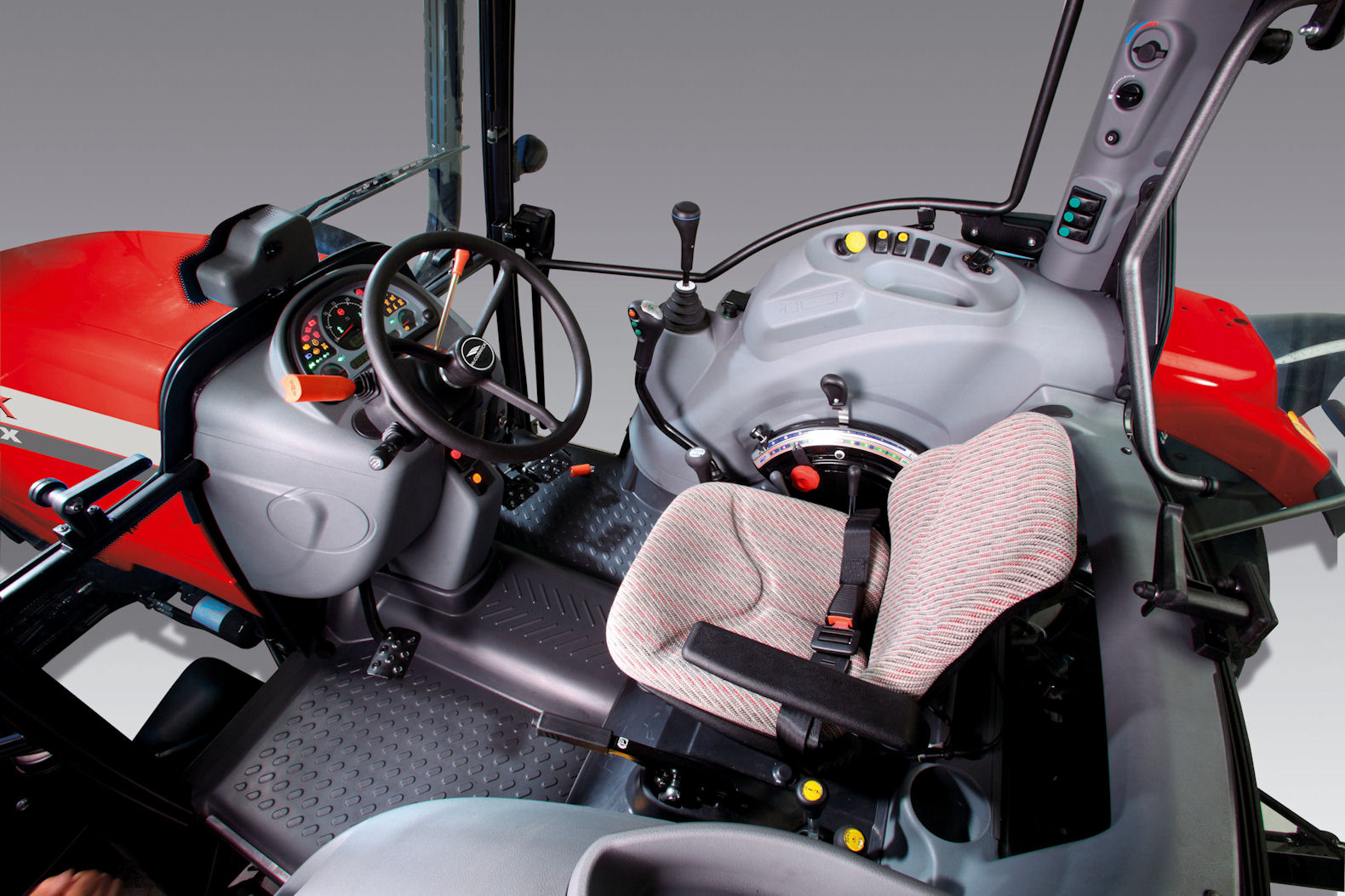 Lots of glass and handy storage pockets feature in the T-Max four-post cab; in this case, on a Power Shuttle version with manual linkage operation.