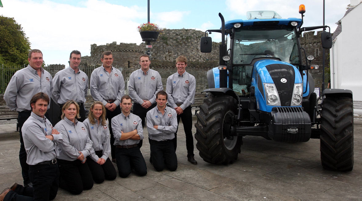 Fferm Ffactor 2011 contestants take a break from filming in Beaumaris, Anglesey alongside their â€˜diary roomâ€™ â€“ the Landini Powermondial 120 tractor.