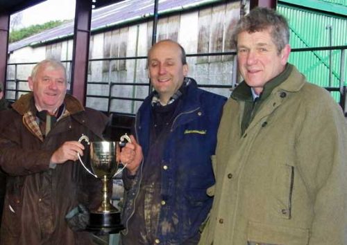 Mike Adams (centre) receives the cup from judge Richard Edwards watched by and Peter Willcock, Halls’ chairman