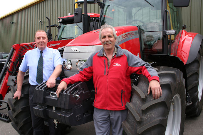 George Marshall (left) and after-sales manager Alan Blaikie with the first stock delivery of McCormick tractors.  