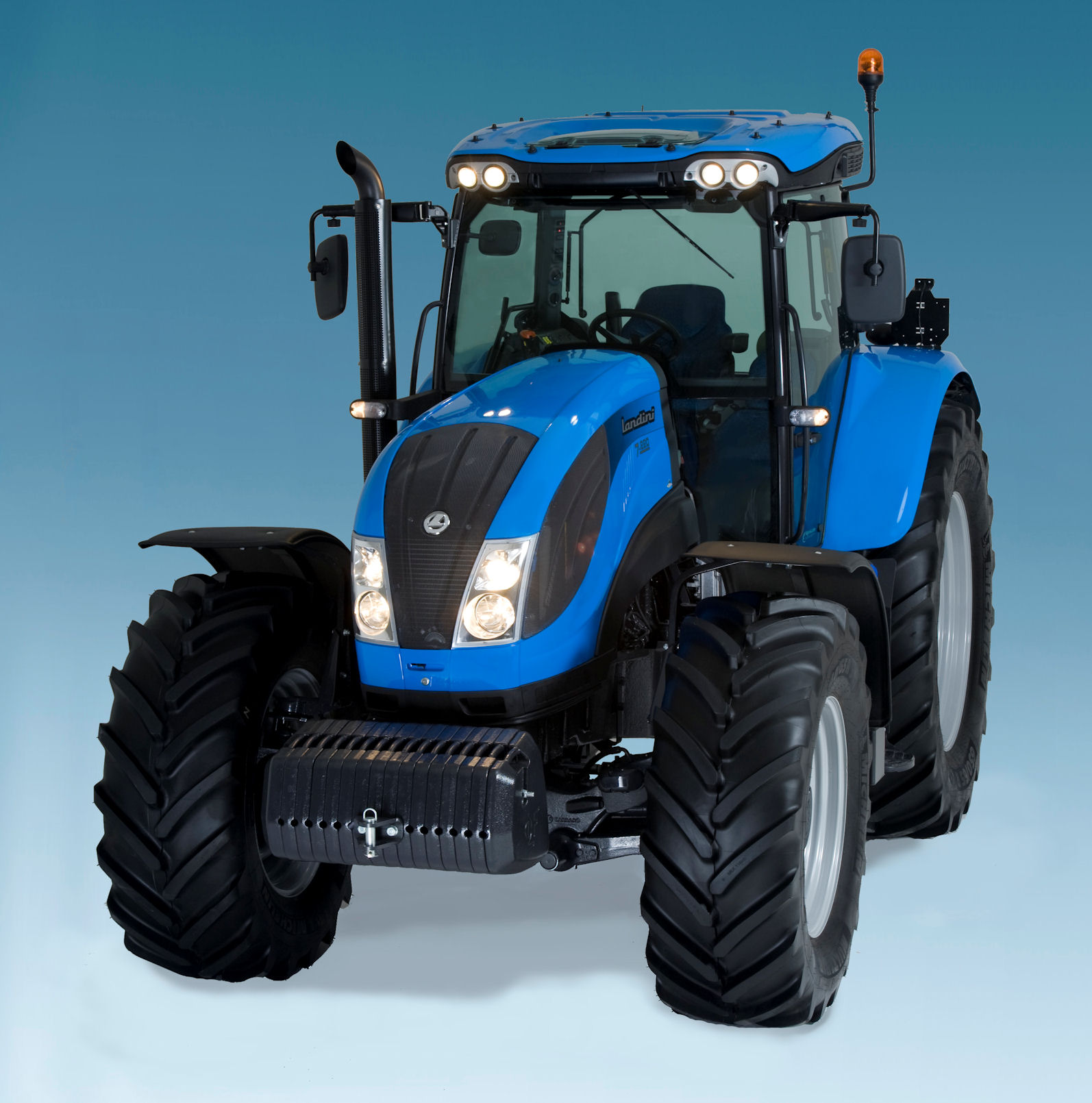 The new tractors are most easily distinguished by the bright-work finish of the work lights and the cab roof window.