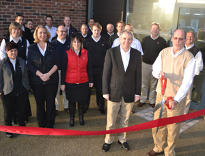 Jerry Moye [right], Cobb president, cuts the ribbon at the opening of the new offices, with Roy Mutimer general manager for Cobb Europe and staff 