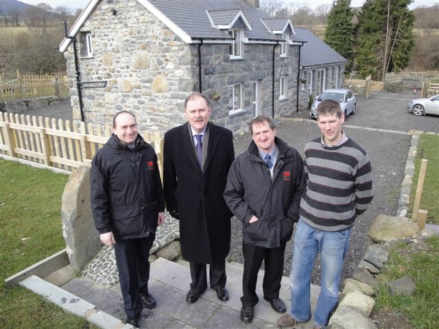 From left, FUW Meirionnydd county executive officer Huw Jones, Dwyfor Meirionnydd MP Elfyn Llwyd, FUW president Emyr Jones and farmer Geraint Edwards outside Talybont cottage.