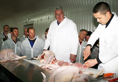 Andy Spencer [left] looks on as David French — both from Poll Hill Garden Centre Butchers, Sevenoaks, Kent — joints a turkey at the poult customers open day