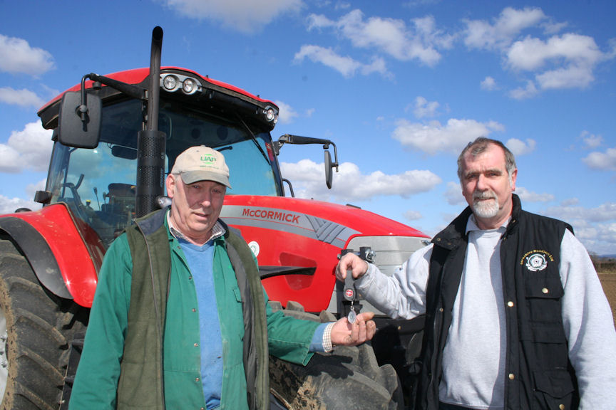 Bill Thompson (left) receives the keys to his tractor from Phil Robinson of new McCormick supplier Yorkshire Handlers.