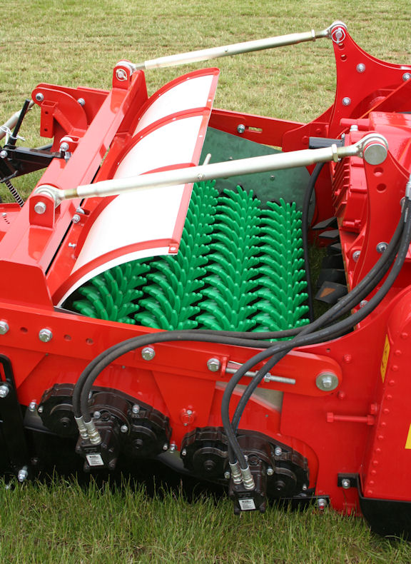 Four flexible finger rollers positioned behind the tiller separate stone and deposit it beneath the bed.