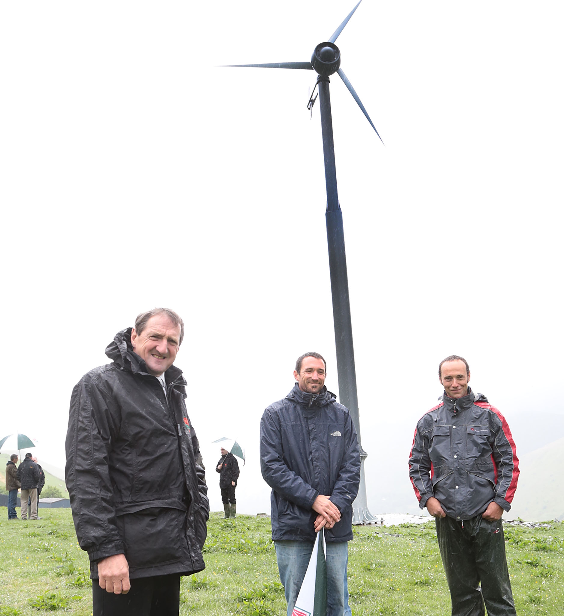 From left, Emyr Jones, Paul Burrell and Dilwyn Pughe at the hilltop location of the wind turbine.