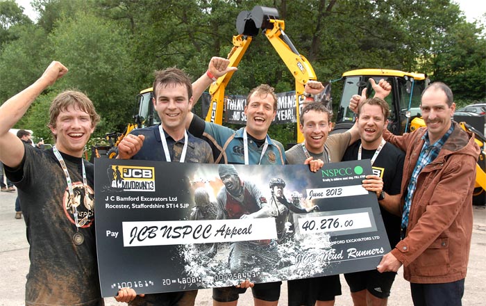 George Bamford (2nd right) presents cheque to John Harrison (right)