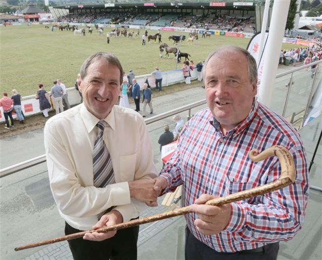 PRESENTATION: FUW president Emyr Jones (left) hands over the crook to John Meredith.