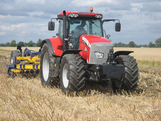 A six-cylinder McCormick X70.70 tractor at work with a subsoiler.