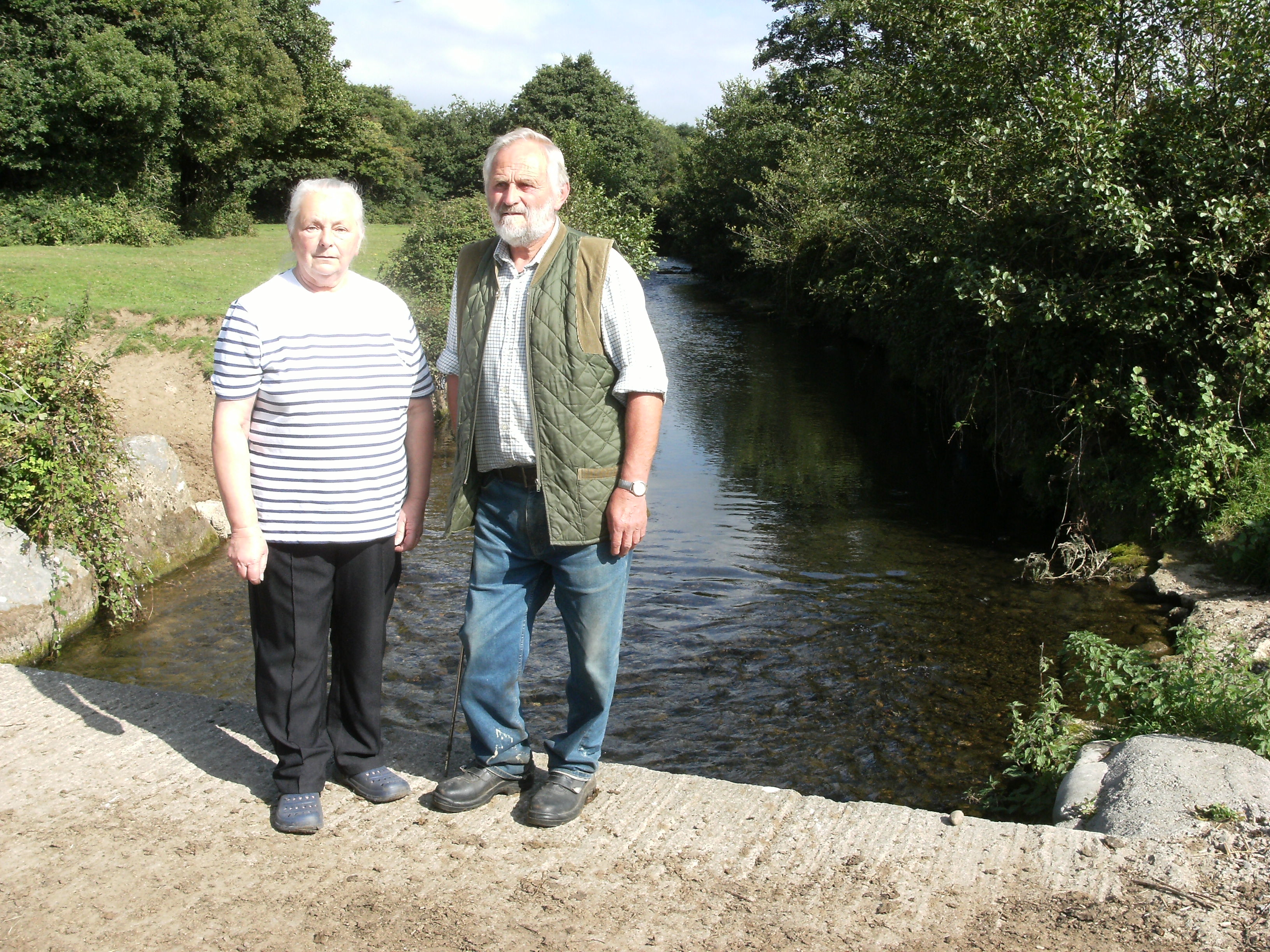 Tom and Beatrice Hayball-Jones alongside the section of river that runs through their land.