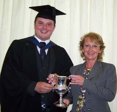 Douglas Fleming receives The Nick Bird Award, an engraved perpetual trophy and a cheque for £500, from Mrs Katie Bird on graduating from Harper Adams University.