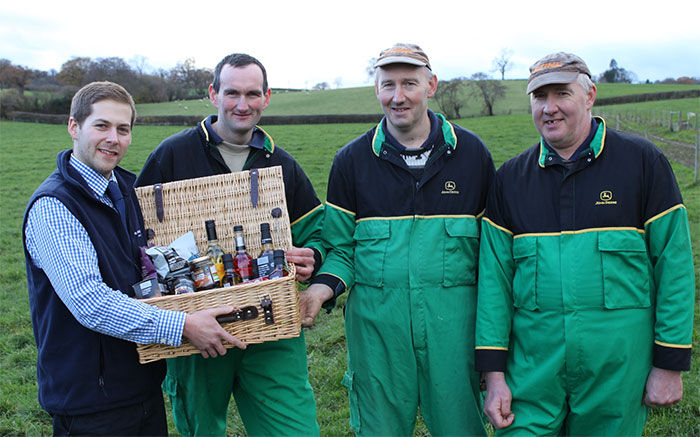 The Co-operative’s Tom Webb presenting a hamper to Neil, Alan and David Pryce.
