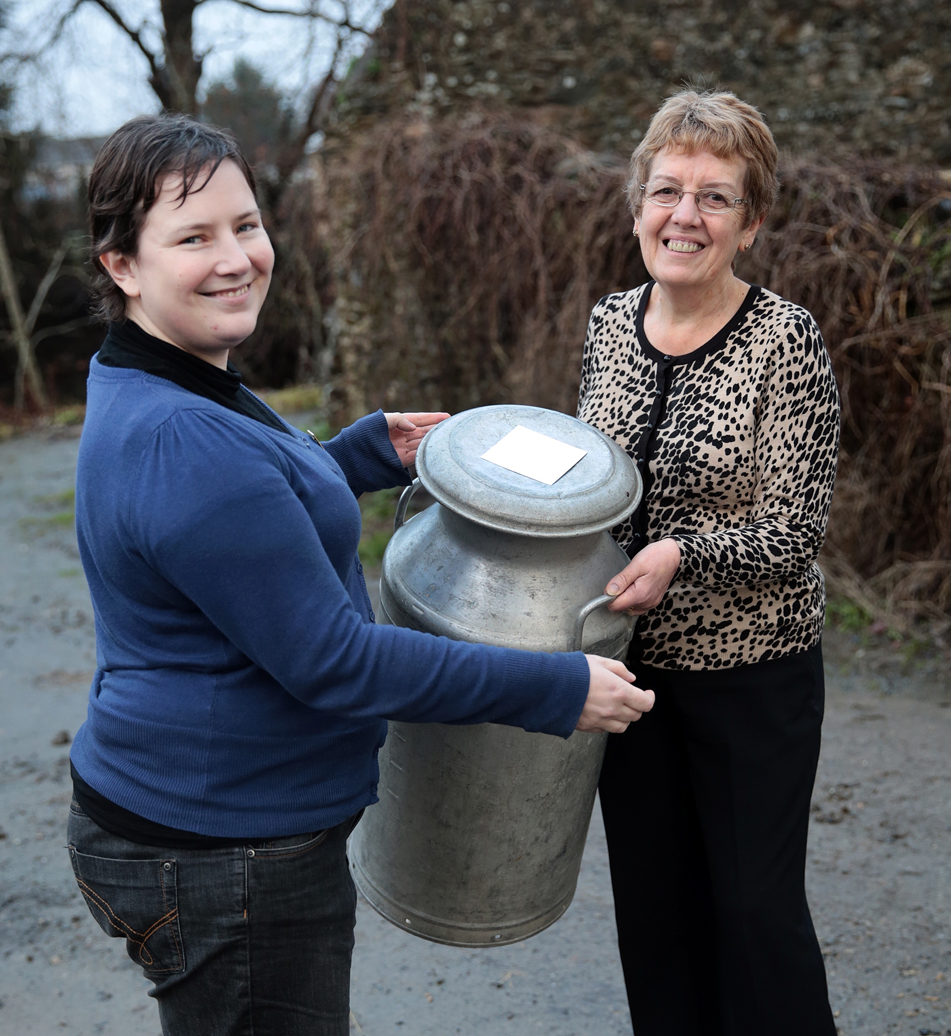 FUW Carmarthenshire county chairman Catherine Nakielny (left) presents Meinir Bartlett with her retirement milk churn present.