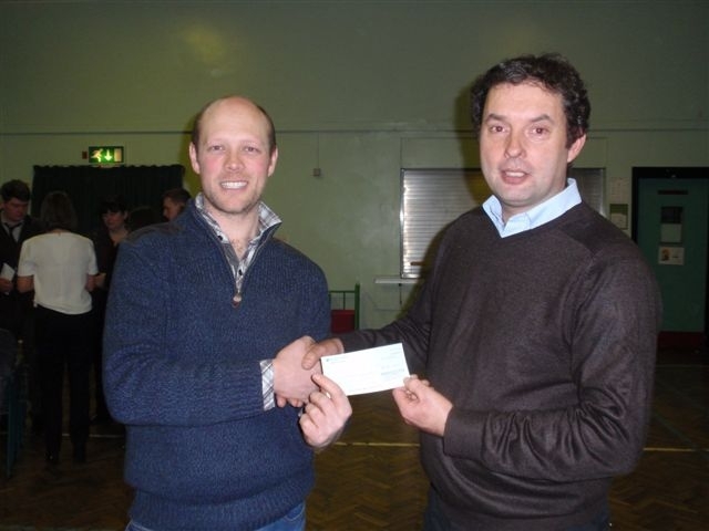 Clwyd YFC chairman Jonathon Hulme (left) receives a cheque from FUW Flintshire member Alan Gardner.