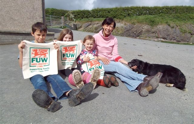 Farmer’s wife Angharad Rowlands of Rhosgoch Farm, Capel Dewi, near Aberystwyth, with her children Aneurin (11), Martha (7) and Elan (3) and dog Floss. The children are holding reusable campaign cotton bags. 