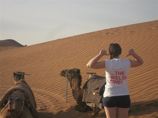 Sian in the Sahara Desert wearing an FUW “Help Cut Food Miles...Buy The Welsh One” campaign tee-shirt.