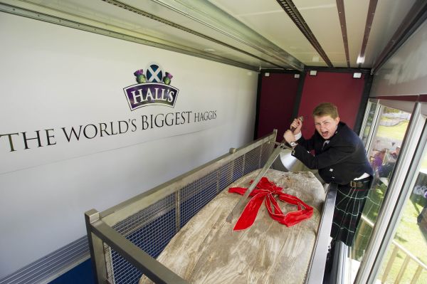 15-year-old Cameron Hill from Kilmarnock cuts into the record-breaking haggis