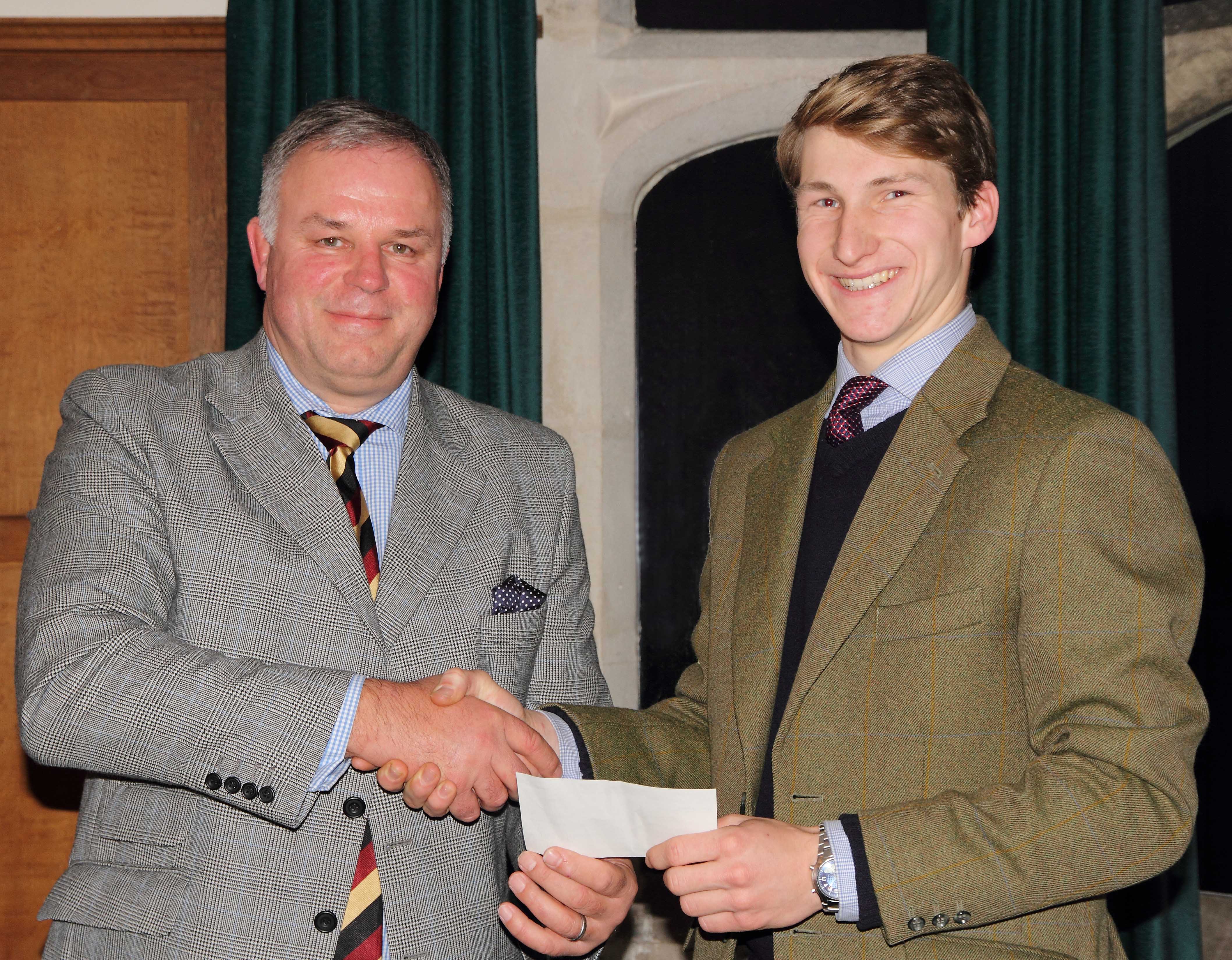 Andrew Jackson, managing partner at Fisher German, presents Tom Vacher with his cheque as part of the Henry Sale Graduate Bursary