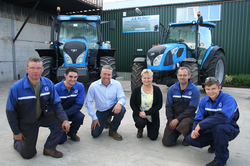 In front of the new Landini 6 Series (left) and 5-H Series tractors are Jason Bloor and administration manager Sharon Millington with (from left) workshop technicians Trevor Williamson, James Greene, Jim Broadhurst and Matt Howell.