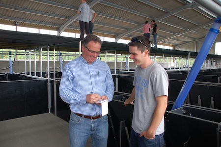 Ben Luxford (right) discusses a technical point with  Jamie Baker, QE’s managing director, during a recent  open day on his farm