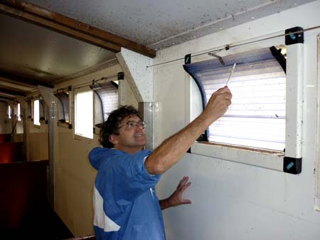 Tim Miller checks an air inlet in a piggery as part of his servicing routine.
