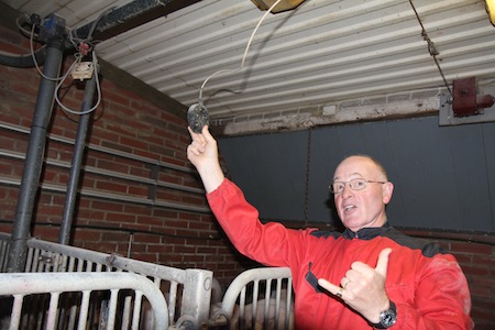 Hugh Crabtree demonstrates the best position of a temperature control sensor — particularly critical with extremes of temperature. The horizontal pipes on the wall carry hot water — necessary to counteract the severe Finnish winters.