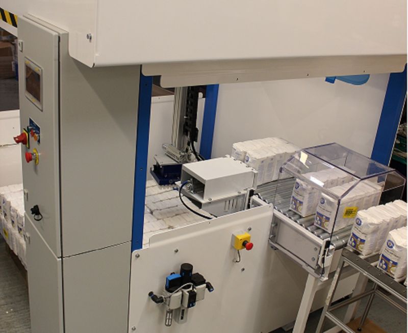 The production line is operating within the structure of the Compact Cartesian Palletiser