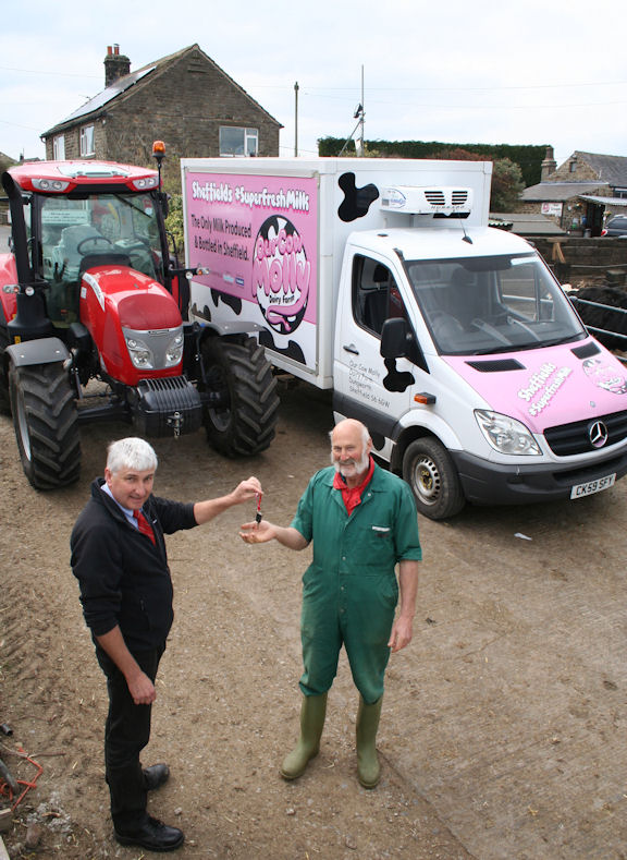 Mick Rimmer from Barlow’s hands over the McCormick tractor's keys to Graham Andrew at Cliffe House Farm.