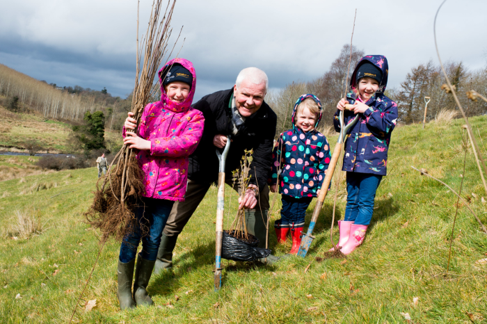 Patrick Cregg of the Woodland Trust, with (left to right) young tree planters Lydia, Beth and Grace Sayers