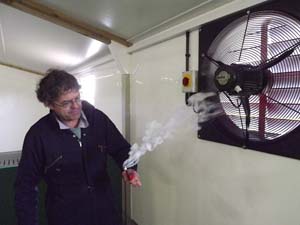 Environmental specialist, Tim Miller, demonstrates the use of smoke to test the efficiency of a fan to move sufficient air at various speeds.