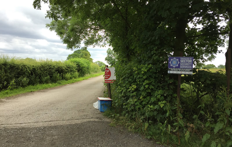 A broken no entry sign and a footbath mark the entrance to the farm showing symptoms of avian influenza