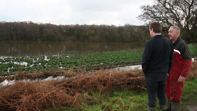 Allan Butler assesses the damage to his land with NFU County Adviser, Adam Briggs