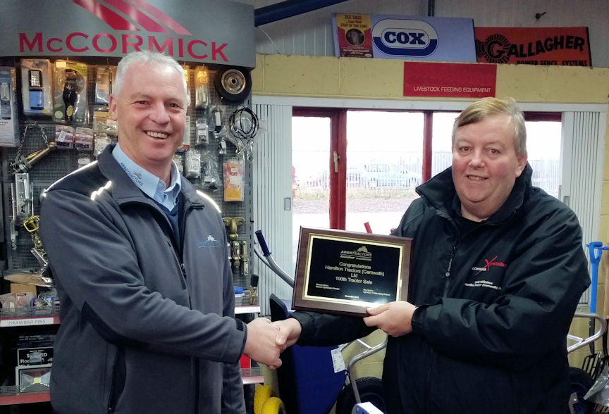 Bob Bain of AgriArgo UK (left) presents a commemorative plaque to David Walkinshaw of Hamilton Tractors.