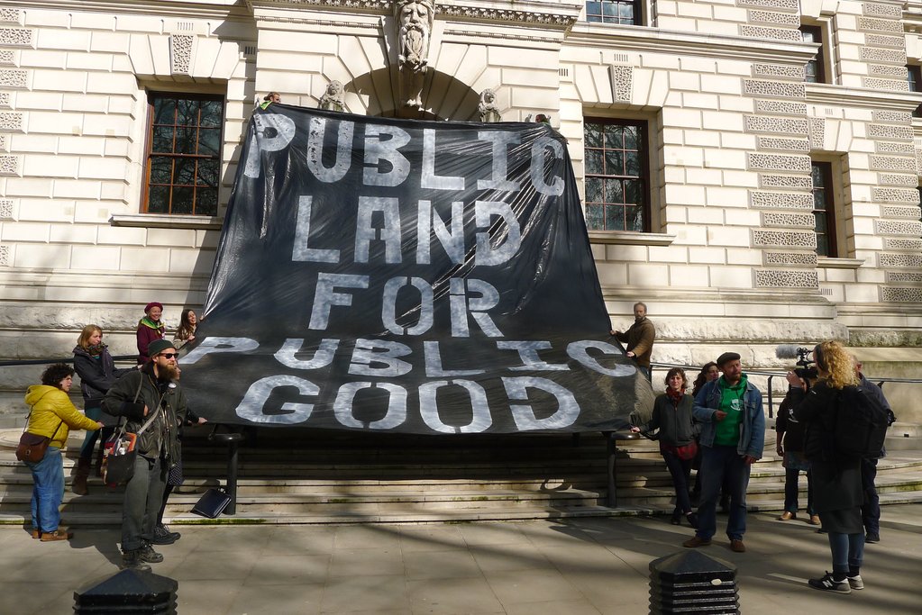 The Landworkers’ Alliance hanging a banner over the Treasury in London