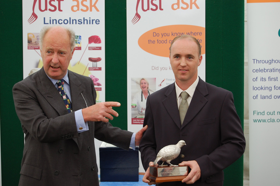  Mr Stewart Watt, farm Manager representing F G Battle & Sons Ltd receives the Lincolnshire Grey Partridge Trophy from the Earl of Romney. 