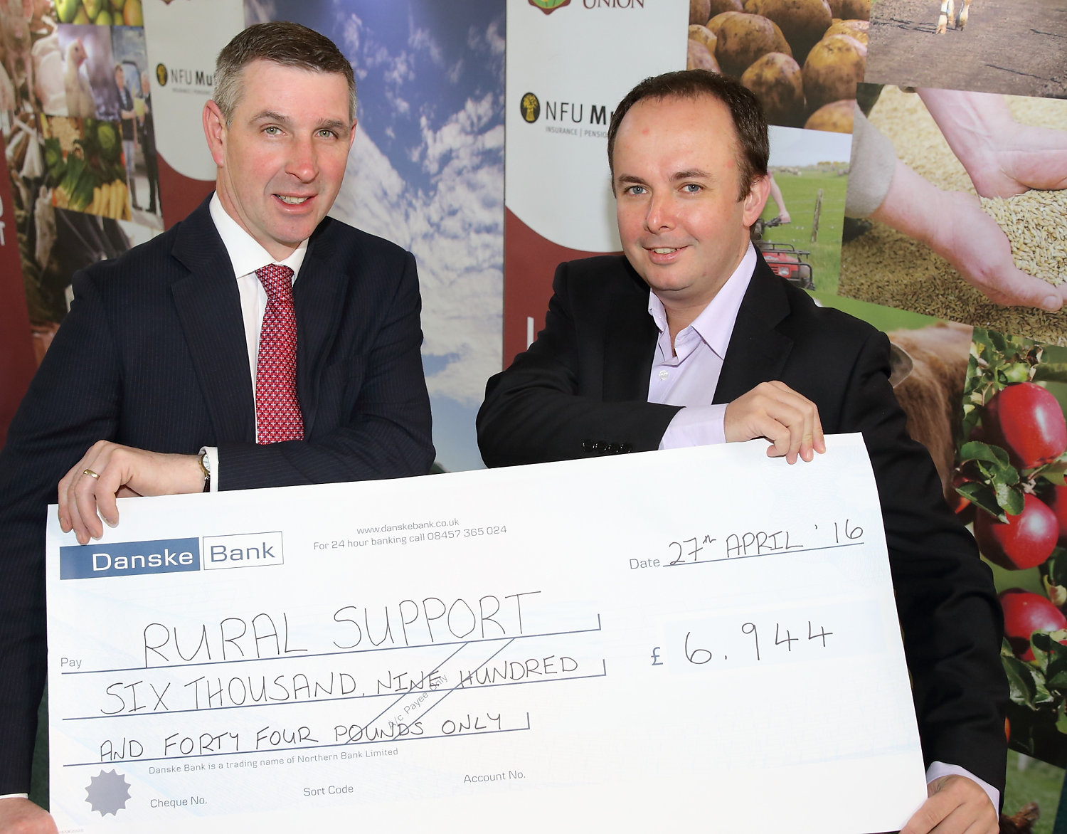 Outgoing President Ian Marshall presents Rural Support Chief Executive Jude McCann with a cheque for £6,944