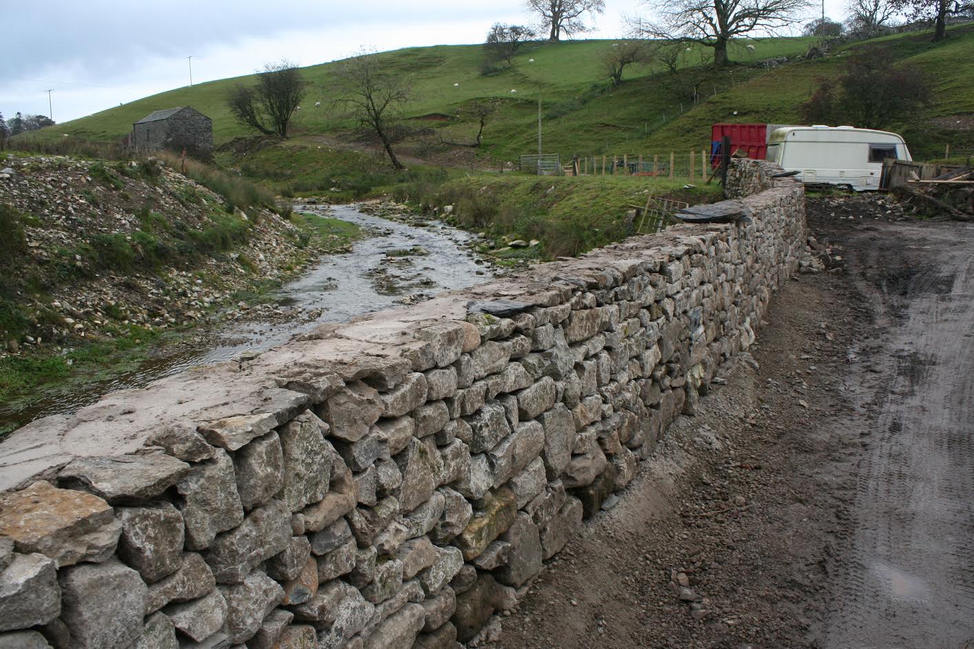 Mr Dunning's stone wall beside the river has been built up again to nearly three times the height it was before the flood