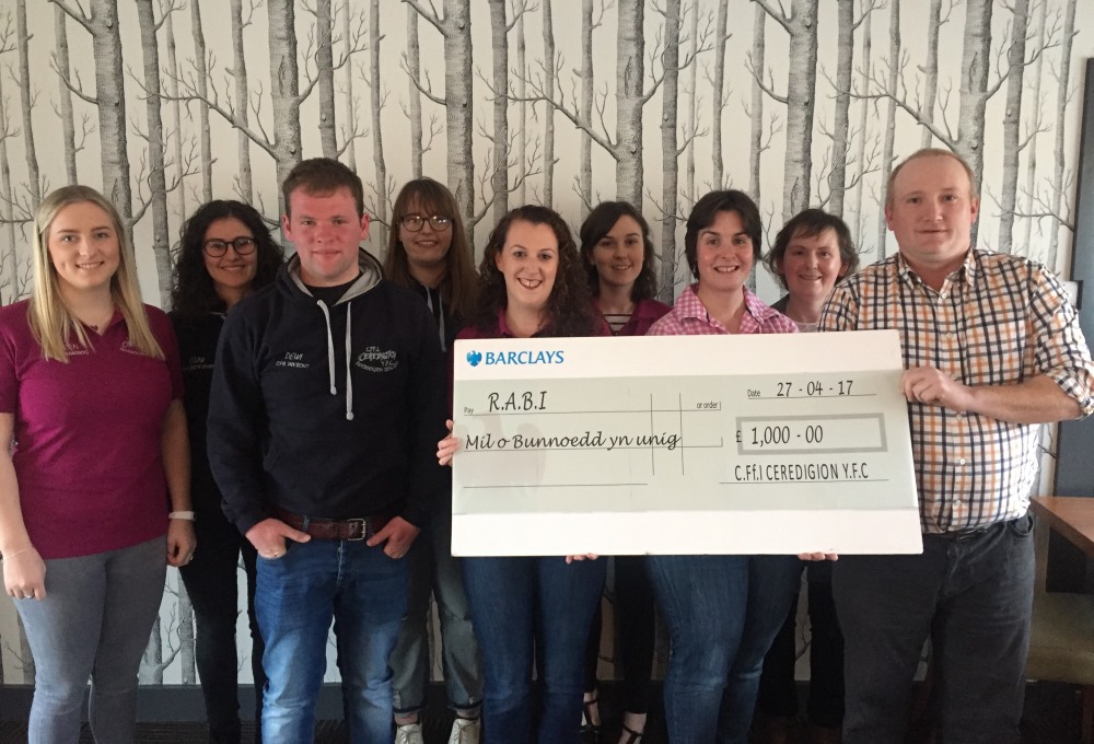 Ceredigion YFC and Young Farmer of the Year presenting R.A.B.I with a cheque