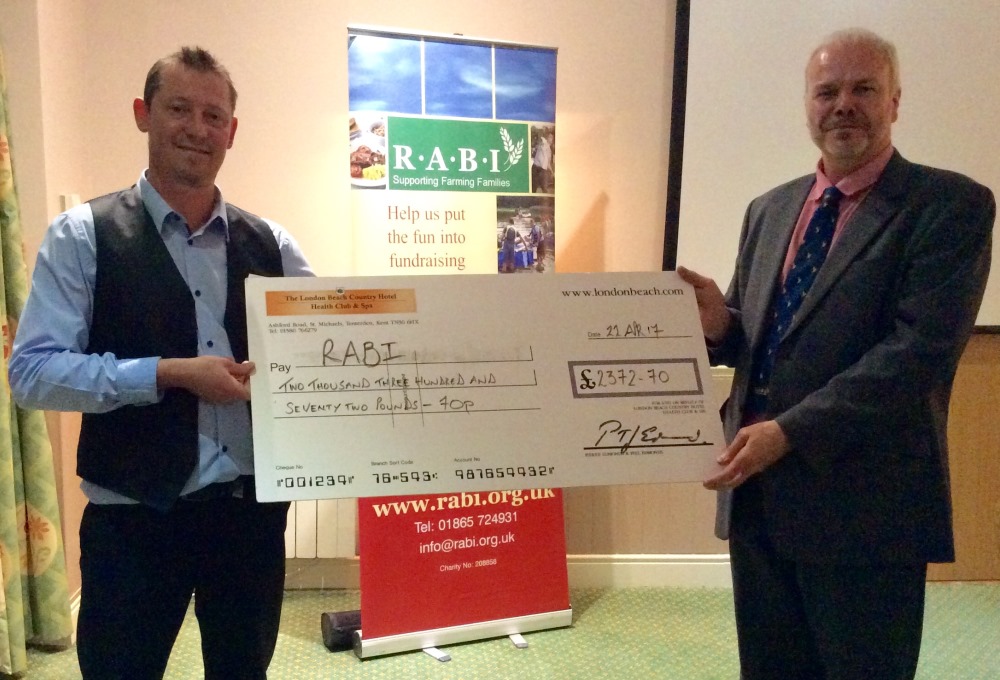 Kent committee chairman Charles Tassell (right) accepting a cheque from a member of staff at the London Beach Hotel