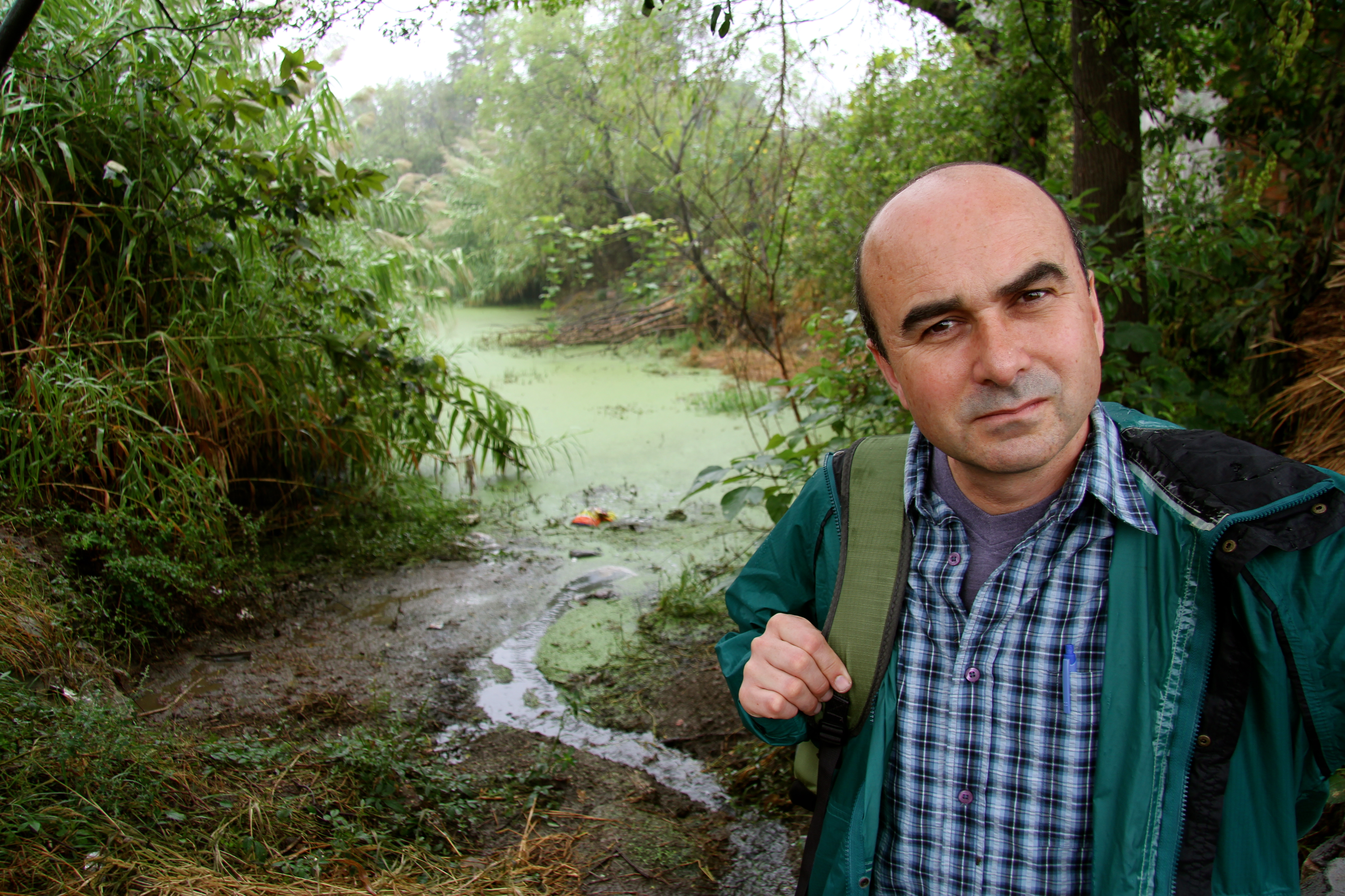 CIWF chief executive Philip Lymbery standing in front of pollution at a pig farm in China