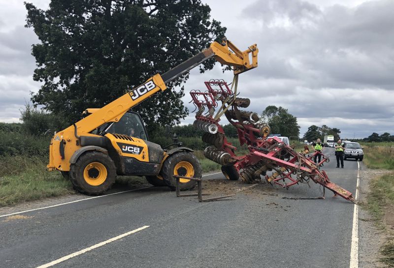 This tractor had to swerve to avoid a car, causing equipment it was carrying to fall off onto the road (Photo: NYPolice)