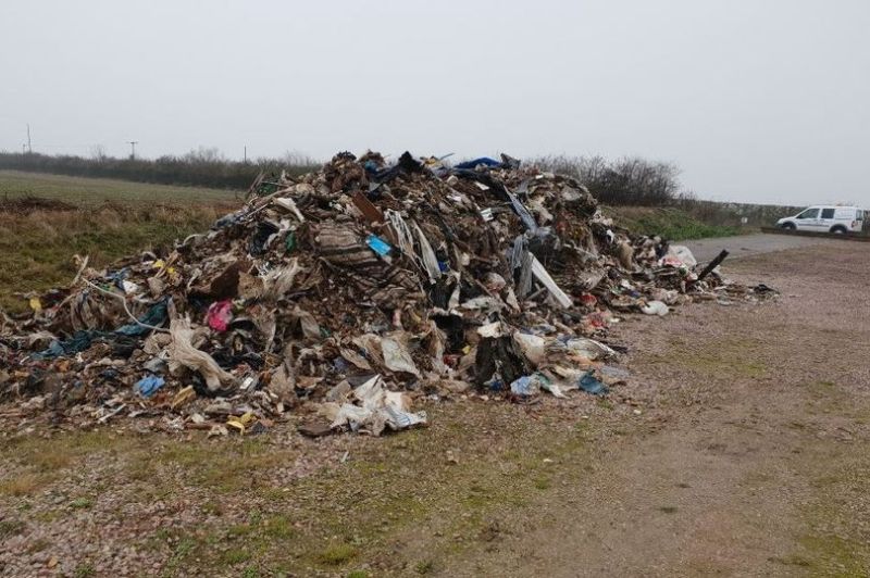 Criminals have dumped 25-tonnes of rubbish on a farm near Godmanchester, Cambridgeshire