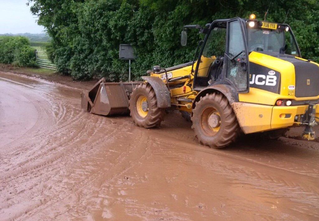 Soil water run off on a Herefordshire road caused by flooding