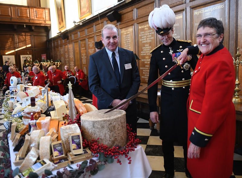 Chelsea Pensioner Monica Parrott, the first ever female Pensioner, cut the ceremonial Montgomery Cheddar